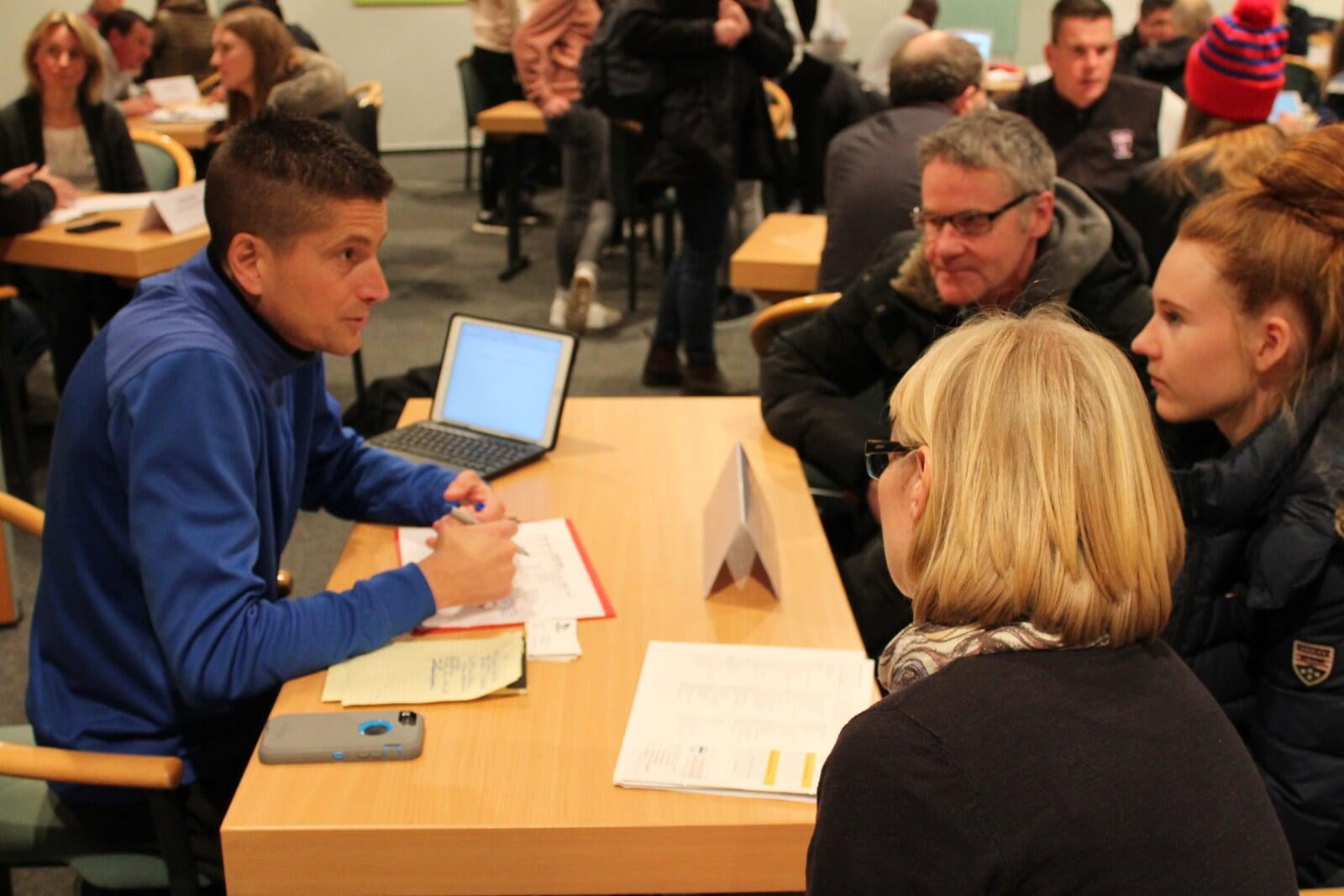 soccer player and parents talking to soccer college-coach