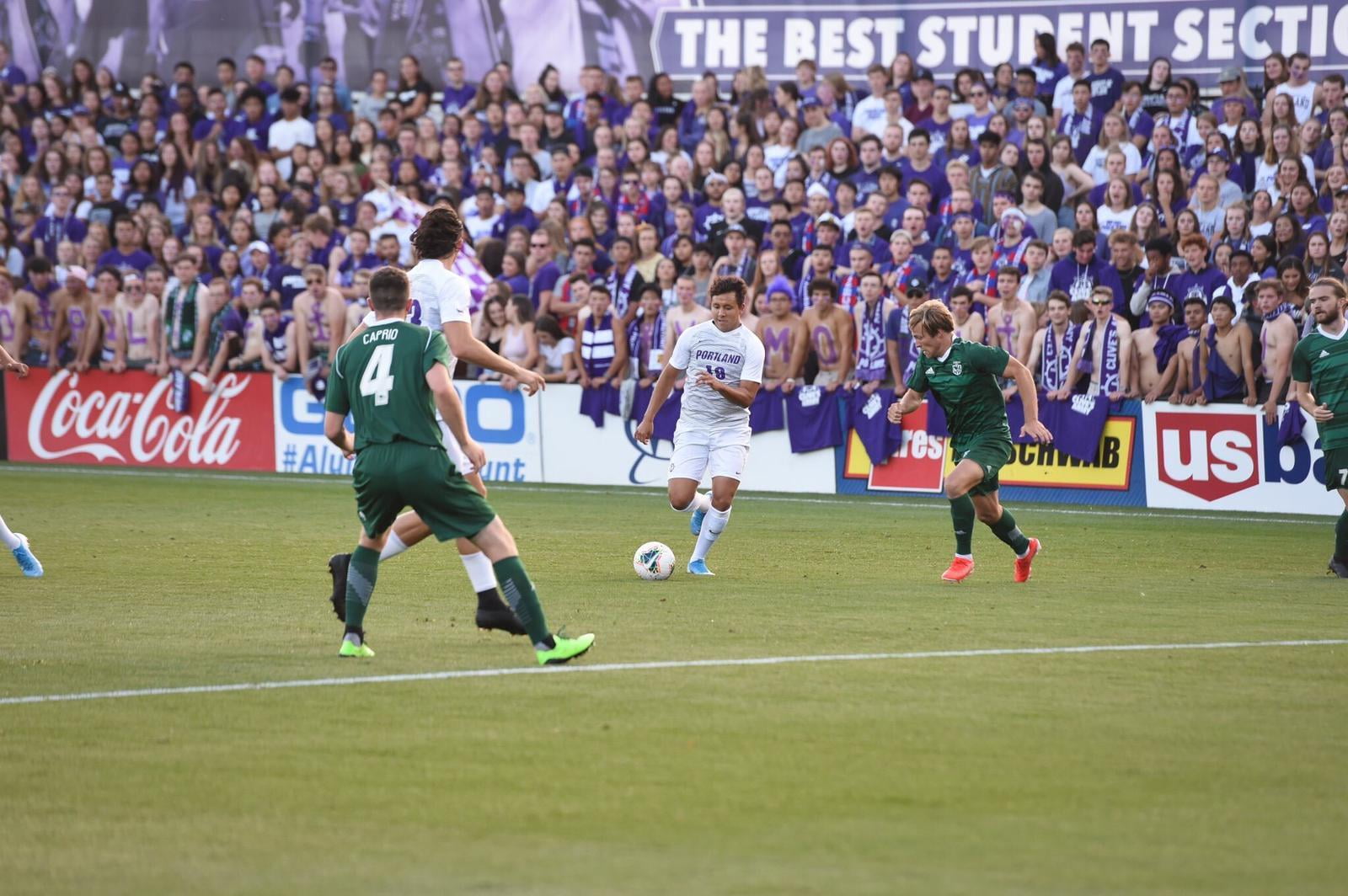 college soccer player in crowded stadium